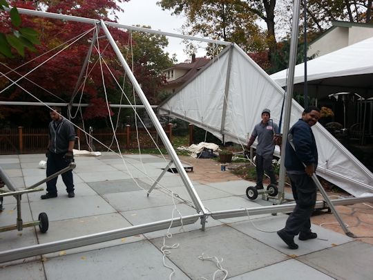 crew installing tents over flooring