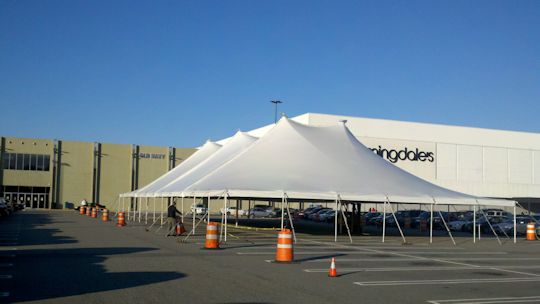 White tentsion tent installed on parking lot