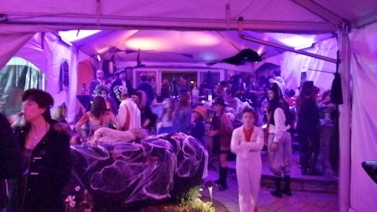 costume party under tent installed on tiered patio